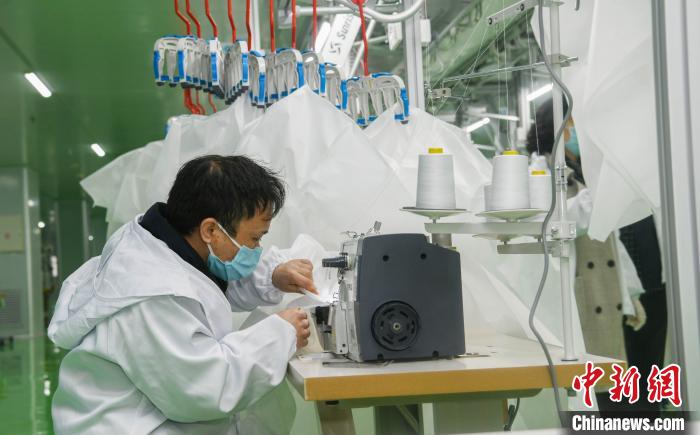 工人生產(chǎn)防護(hù)服，保障抗疫物資供應(yīng)。廣安市委宣傳部供圖