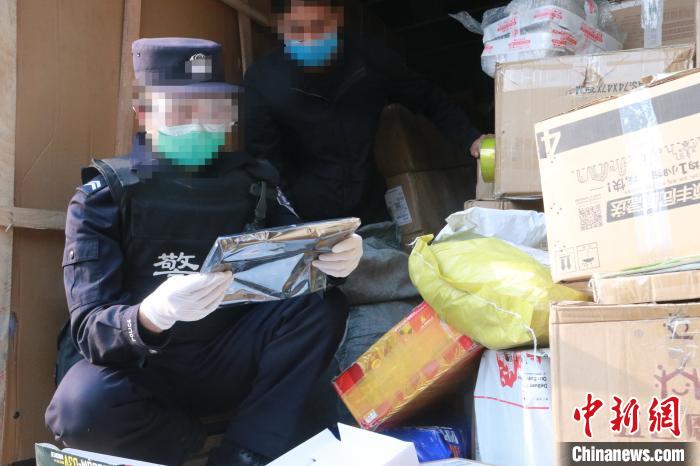 圖為勐康邊檢站民警在對快遞運(yùn)輸車輛進(jìn)行例行檢查?！钐?攝